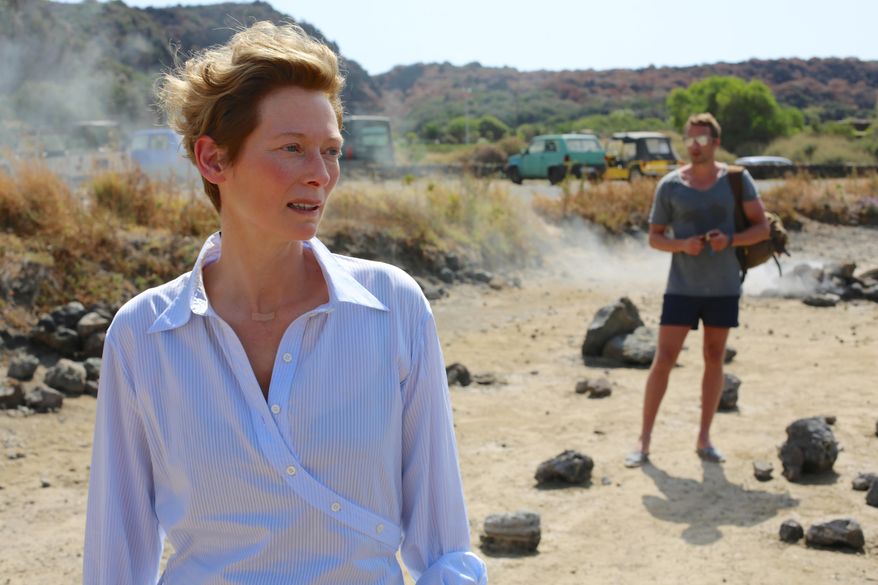 This image released by Fox Searchlight shows Tilda Swinton, left, and Matthias Schoenaerts in a scene from "A Bigger Splash," in theaters on May 4. (Jack English/Fox Searchlight via AP)