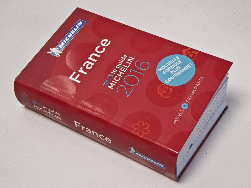 FILE - In this Feb.1, 2016 file photo, the Michelin Guide 2016 is pictured in Paris. The leader of an umbrella organization representing world Jewry has asked the Michelin travel guide company to evaluate Israeli restaurants with its famous rating system, implying that the decision to omit the country may be political. (AP Photo/Michel Euler, File)