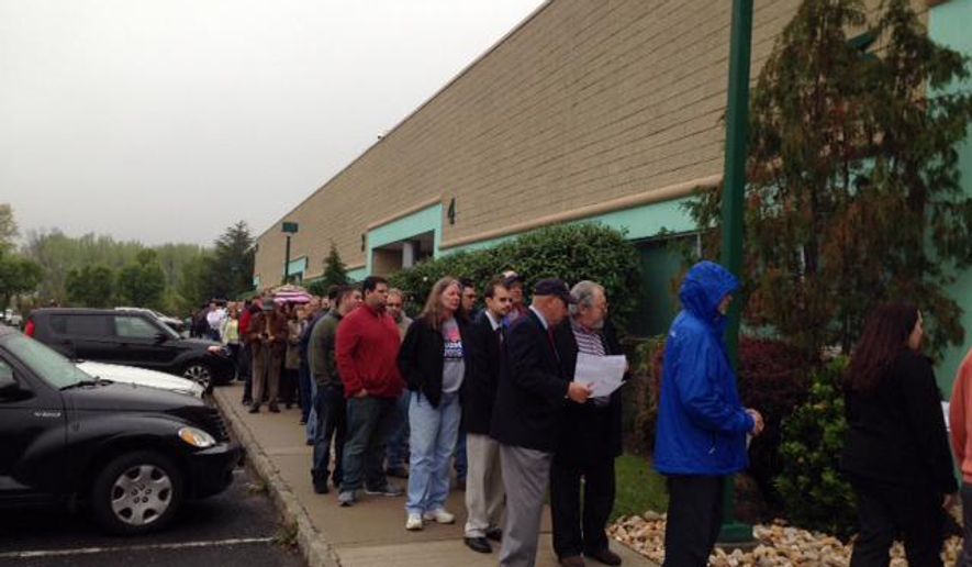 At least 100 people turn out for Republican presidential candidate Donald Trump's campaign office opening Tuesday, May 3, 2016, in Edison, N.J. The opening of the headquarters in a suburban office park took place on Tuesday, just as the businessman's primary victory in Indiana was announced. (AP Photo/Michael Catalini)