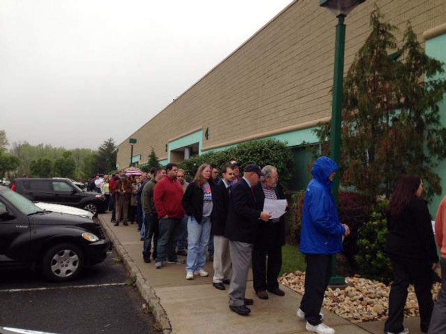 At least 100 people turn out for Republican presidential candidate Donald Trump's campaign office opening Tuesday, May 3, 2016, in Edison, N.J. The opening of the headquarters in a suburban office park took place on Tuesday, just as the businessman's primary victory in Indiana was announced. (AP Photo/Michael Catalini)
