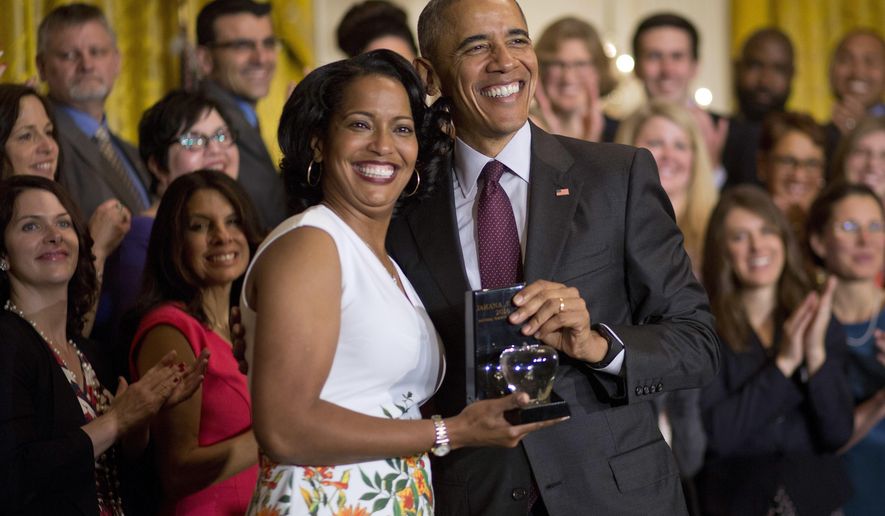 President Barack Obama awards the 2016 National Teacher of the Year to Jahana Hayes, Tuesday, May 3, 2016, during a ceremony in the East Room of the White House in Washington. Hayes is a Social Studies yeacher at John F. Kennedy High School in Waterbury, Conn. (AP Photo/Pablo Martinez Monsivais)