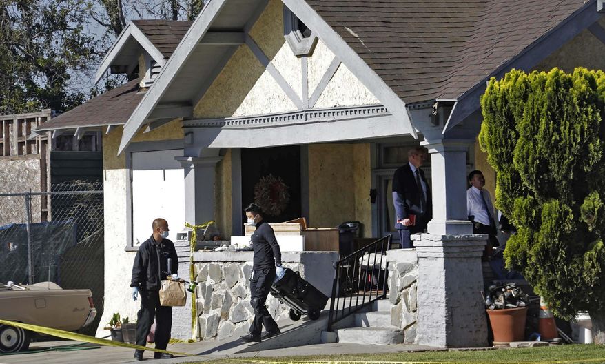 Los Angeles police investigate a stabbing at a house in Los Angeles on Tuesday, May 3, 2016. Donald Gray is suspected of stabbing his live-in girlfriend and her 2-year-old daughter in their home, killing the little girl and critically wounding her mother, who was five months pregnant, authorities said. (AP Photo/Nick Ut)