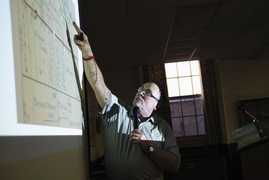 In this April 11, 2016 photo, John Thompson, president of the Dixon Area Chamber of Commerce and Industry, points to a map while telling the story of the 1885 Bloody Gulch murder during the Dixon Founder's Day celebration in Dixon, Ill. The murder of 17-year-old Bible salesman Frank Charles Thiel in 1885 inspired the naming of Bloody Gulch Road. (Alex T. Paschal/The Telegraph via AP) /The Telegraph via AP) MANDATORY CREDIT
