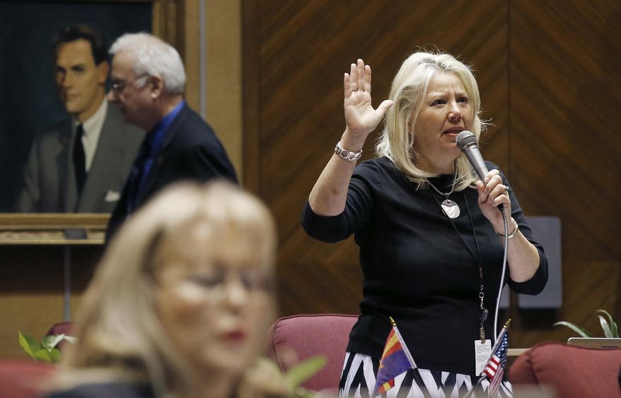 Sen. Debbie Lesko, right, R-Peoria, speaks about SB1257, a bill allowing concealed-carry permit holders to take firearms into some public buildings, on the Senate floor at the Arizona Capitol Wednesday, May 4, 2016, in Phoenix. The bill was rejected on a 14-14 vote, but could come back under reconsideration rules. (AP Photo/Ross D. Franklin)