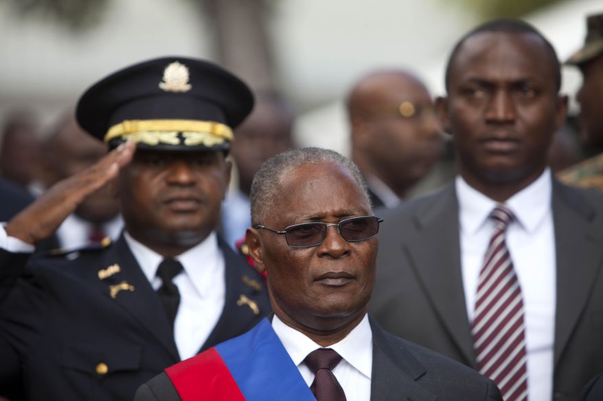 FILE - In this Feb. 14, 2016, file photo, Haiti's provisional President Jocelerme Privert stands for the national anthem after delivering his speech at an installation ceremony, in Port-au-Prince, Haiti. Haitian lawmakers chose Privert, the country's former Senate chief to lead a caretaker government to fill the void left by the departure of ex-President Michel Martelly. (AP Photo/Dieu Nalio Chery)