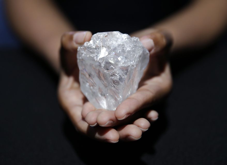 A model displays a large diamond at Sotheby's in New York, Wednesday, May 4, 2016. The auction house plans to offer the Lesedi la Rona diamond in London on June 29. (AP Photo/Seth Wenig)