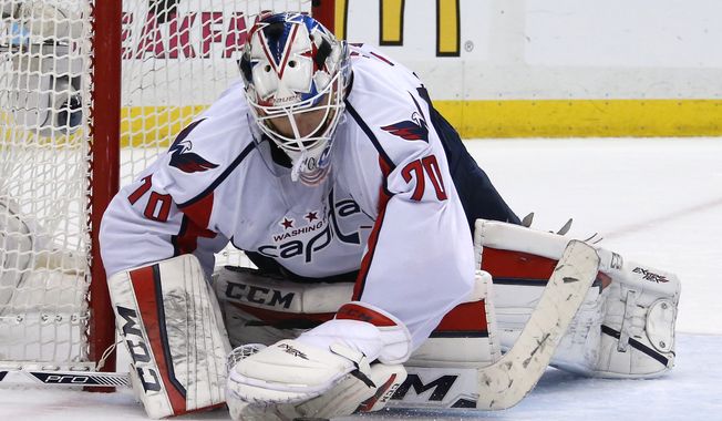 Washington Capitals goalie Braden Holtby (70) stops a shot during the second period of Game 4 in an NHL hockey Stanley Cup Eastern Conference semifinals against the Pittsburgh Penguins in Pittsburgh, Wednesday, May 4, 2016. (AP Photo/Gene J. Puskar)