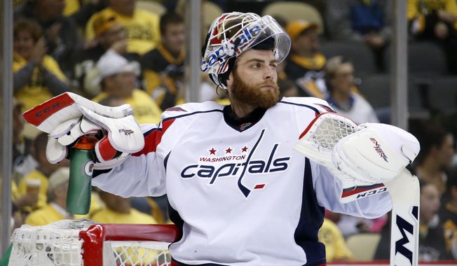 Washington Capitals goalie Braden Holtby takes a time out during the second period of Game 3 in an NHL hockey Stanley Cup Eastern Conference semifinals against the Pittsburgh Penguins in Pittsburgh, Monday, May 2, 2016. (AP Photo/Gene J. Puskar)