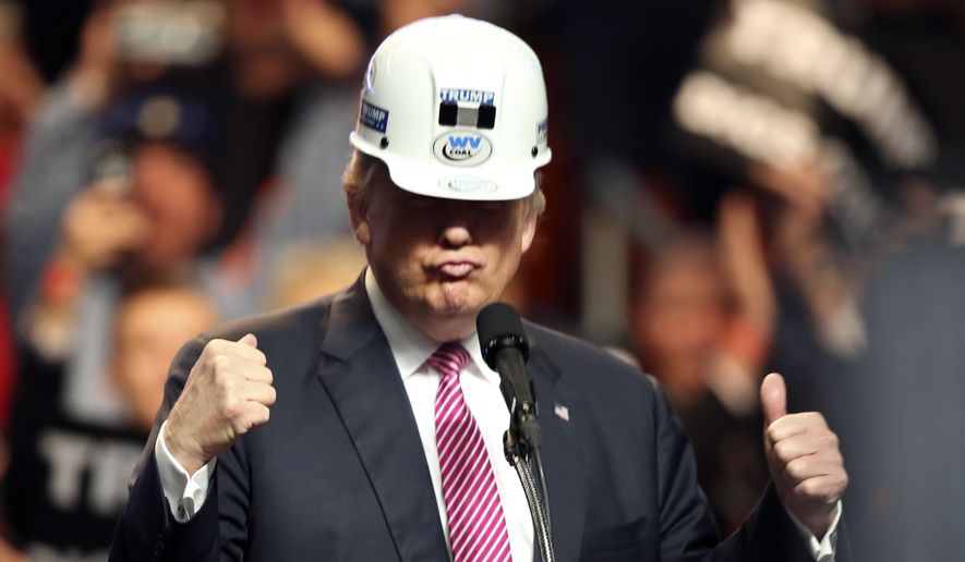 Republican presidential candidate Donald Trump puts on a miners hard hat during a rally in Charleston, W.Va., Thursday, May 5, 2016. (AP Photo/Steve Helber)