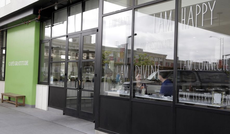 This Wednesday, May 4, 2016 photo shows Cafe Gratitude restaurant in Los Angeles. At the Cafe Gratitude restaurant chain in California, waiters serve plates of vegan rice bowls, vegetable pizzas and tempeh sandwiches with names like "Gracious," ''Warm-Hearted" and "Magical." Angry patrons and animal rights activists are calling on vegans to boycott the restaurant after learning that owners Matthew and Terces Engelhart have begun eating meat and consuming animals raised on their private farm. (AP Photo/Nick Ut)