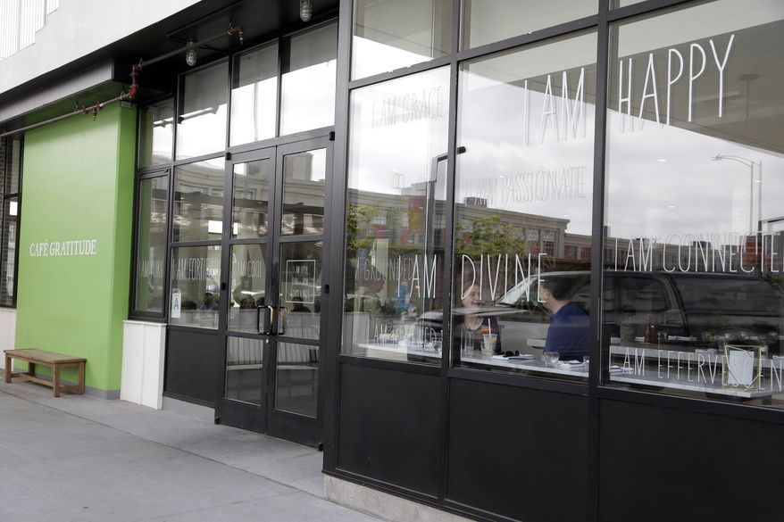 This Wednesday, May 4, 2016 photo shows Cafe Gratitude restaurant in Los Angeles. At the Cafe Gratitude restaurant chain in California, waiters serve plates of vegan rice bowls, vegetable pizzas and tempeh sandwiches with names like "Gracious," ''Warm-Hearted" and "Magical." Angry patrons and animal rights activists are calling on vegans to boycott the restaurant after learning that owners Matthew and Terces Engelhart have begun eating meat and consuming animals raised on their private farm. (AP Photo/Nick Ut)