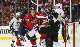Washington Capitals defenseman John Carlson (74) and Pittsburgh Penguins center Evgeni Malkin (71) shove each other in from of the net during the third period of Game 5 in an NHL hockey Stanley Cup Eastern Conference semifinals Saturday, May 7, 2016 in Washington. Washington won 3-1. (AP Photo/Pablo Martinez Monsivais)
