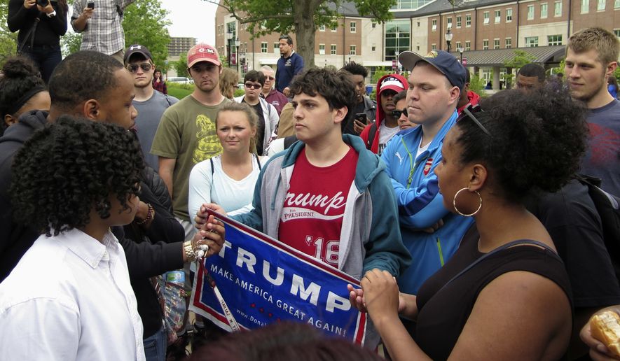 Student protesters at Southern Illinois University in Carbondale confront a lone Donald Trump supporter at a campus rally on May 2. (Associated Press)