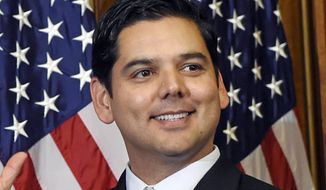 In this Jan. 6, 2015, file photo, Rep. Raul Ruiz, D-Calif., reenacts his swearing-in to Congress on Capitol Hill in Washington. (AP Photo/Susan Walsh, File)  **FILE**