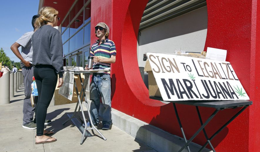 In this Saturday April 23, 2016, photo, petition signature gatherer Peter Keyes, right, discusses a petition to legalize marijuana, in Sacramento, Calif. It&#39;s a banner year in California for paid signature-gathers, like Keyes. (AP Photo/Rich Pedroncelli)