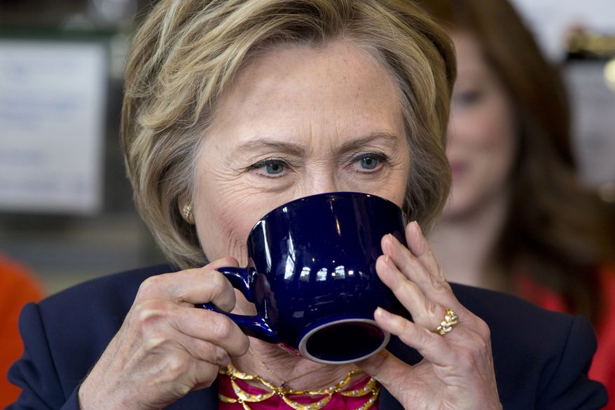 Democratic Presidential Candidate Hillary Clinton drinks while speaking to parents of young children at Mug'N Muffin in Stone Ridge, Va., Monday, May 9, 2016. (AP Photo/Jacquelyn Martin)