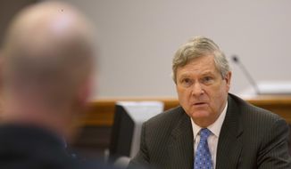 Then-U.S. Secretary of Agriculture Tom Vilsack talks with former heroin addict Chris Overka at a meeting at the Hillsborough County Superior Court, Monday, May 9, 2016, in Nashua, N.H., to hear about its drug court program. (AP Photo/Jim Cole) ** FILE **