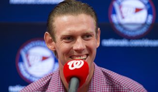 Washington Nationals starting pitcher Stephen Strasburg smiles during a news conference to announce a seven-year contract extension that will pay Strasburg $175 million starting in 2017, at Nationals Park, on Tuesday, May 10, 2016, in Washington. (AP Photo/Evan Vucci)