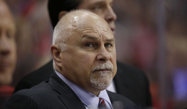 Washington Capitals head coach Barry Trotz stands in the bench in the second period of an NHL hockey game against the New York Islanders, Tuesday, April 5, 2016, in Washington. (AP Photo/Alex Brandon)