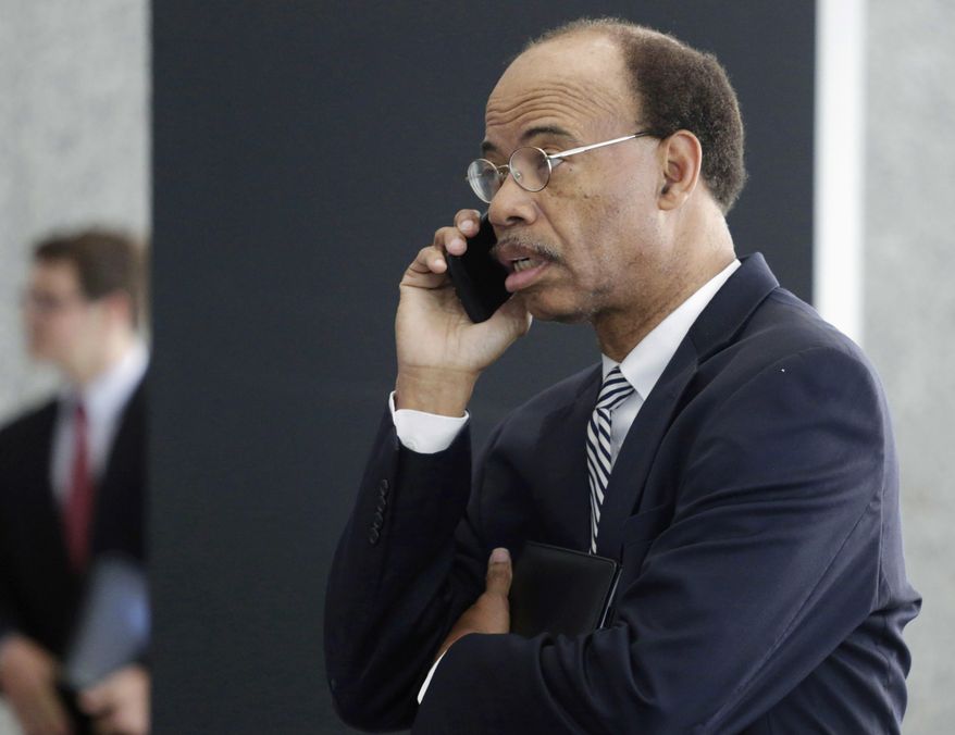 FILE - In this July 30, 2015, file photo, former Illinois U.S. Rep. Mel Reynolds talks on his cell phone as he leaves federal court in Chicago. In a handwritten filing posted Tuesday, May 10, 2016, Reynolds says he wants to plead guilty to misdemeanor federal charges of failing to file a tax return. (AP Photo/M. Spencer Green, File)
