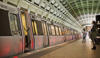 In this photo taken March 12, 2015, passengers wait on the platform before boarding a train at the U Street Metro Station in Washington. (AP Photo/Pablo Martinez Monsivais) 