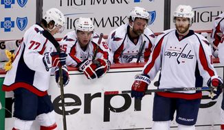 Washington Capitals&#39; T.J. Oshie (77), Andre Burakovsky (65), Justin Williams (14) and Mike Richards (10) gather at their bench after the Capitals lost to the Pittsburgh Penguins in overtime of Game 6 of the NHL hockey Stanley Cup Eastern Conference semifinals, Tuesday, May 10, 2016 in Pittsburgh. The Penguins won 4-3 and advanced to the next round. (AP Photo/Gene J. Puskar)