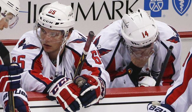 Washington Capitals&#x27; Andre Burakovsky (65) and Justin Williams (14) sit on the bench after the Capitals lost to the Pittsburgh Penguins in overtime of Game 6 of the NHL hockey Stanley Cup Eastern Conference semifinals, Tuesday, May 10, 2016 in Pittsburgh. The Penguins won 4-3 and advanced to the conference finals. (AP Photo/Gene J. Puskar)