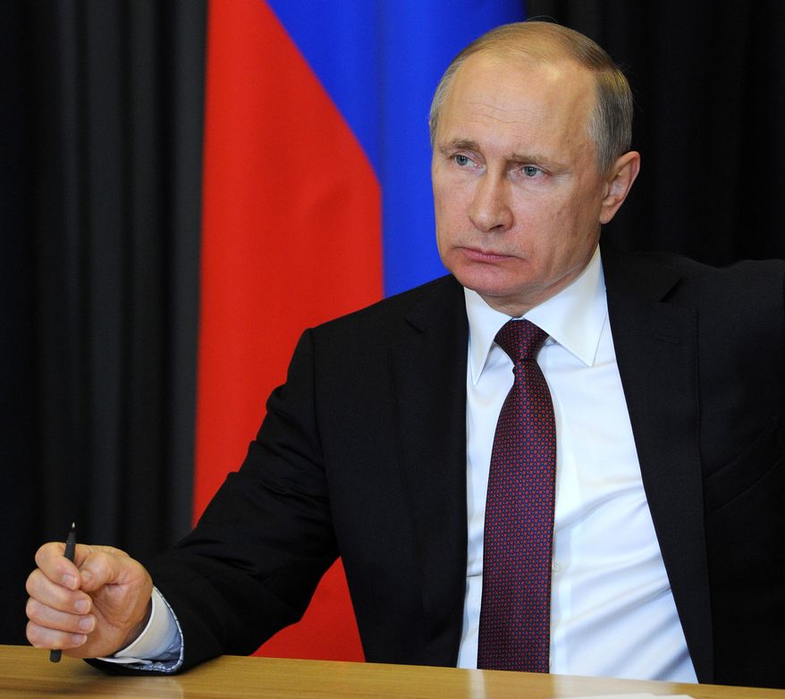 Russian President Vladimir Putin listens during a live video link with regions suffering from forest fires from the Bocharov Ruchei residence in the Russian Black Sea resort of Sochi on Wednesday, May 11, 2016. Russia’s president has flipped the switch to open the last of four electricity lines to Crimea aimed at allowing the Russia-annexed peninsula to end its reliance on Ukrainian electricity. (Mikhail Klimentyev/Sputnik, Kremlin Pool Photo via AP)