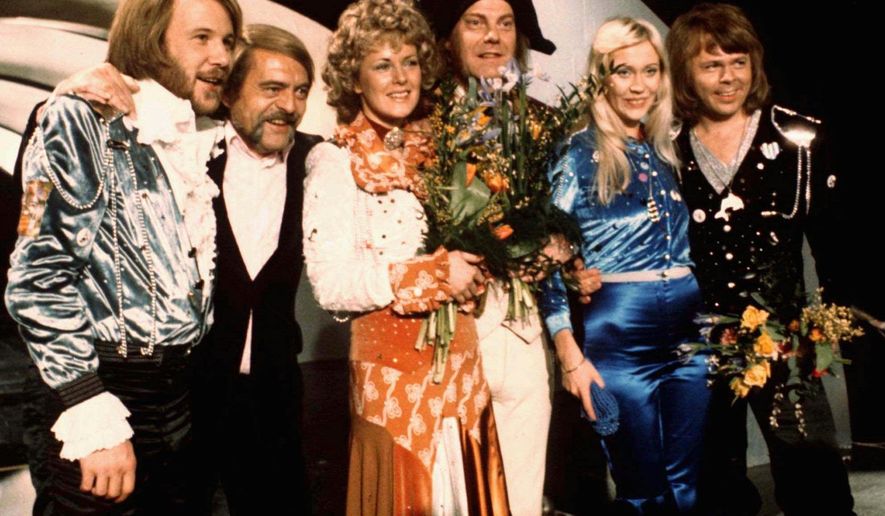 FILE - In this April 6, 1974 file photo, members of Swedish group ABBA and close associates celebrate the victory of their song "Waterloo" in the Eurovision Song Contest in Brighton, England. The four members of ABBA, Benny Andersson, left, Annifrid Lyngstad, third left, Agnetha Faltskog, second right, and Bjorn Ulvaeus, right, , second right, were the most successful winners of the Eurovision Song Contest, enjoying unprecedented success after their victory. The final of this year's competition takes place on Saturday, May 14 in the Swedish capital Stockholm. (AP Photo/File)