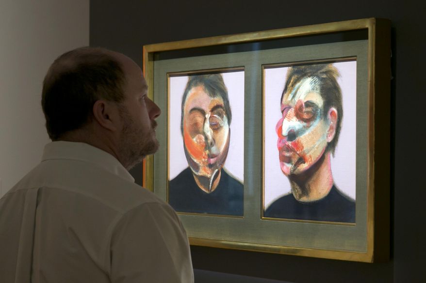 FILE- In this Friday, March 29, 2016 photo, Francis Bacon's "Two Studies for a Self-Portrait" is viewed during the spring auction preview at Sotheby's, in New York. Bacon's double-panel self-portrait and a Cy Twombly “Blackboard” painting executed in blue, both in private collections for decades, are the top highlights at Sotheby’s auction of contemporary art on Wednesday, May 11. (AP Photo/Richard Drew, File)