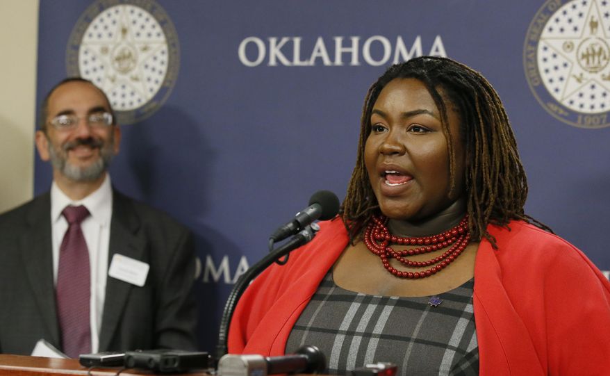 Devon Douglass, right, of the Oklahoma Assets Network and Oklahoma Policy Institute, speaks during a news conference in Oklahoma City, Wednesday, May 11, 2016, in opposition to state budget plans that threaten tax credits for low to moderate income families and seniors. At left is David Blatt, executive director, Oklahoma Policy Institute. (AP Photo/Sue Ogrocki)