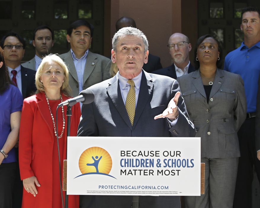 Eric Heins, president of the California Teachers Association, answers questions concerning a proposed ballot initiative asking voters to extend a temporary income tax increase on the wealthy, at a news conference, Wednesday, May 11, 2016, in Sacramento, Calif. Accompanied by representatives of other unions, hospitals and doctor's, Heins said they will turn in more then enough signatures to qualify the initiative for the November ballot. (AP Photo/Rich Pedroncelli)