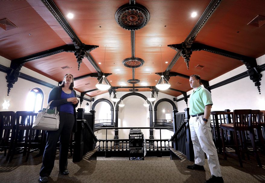 CORRECTS NEWSPAPER TO WISCONSIN STATE JOURNAL - ADVANCE FOR USE MONDAY, MAY 16 - In this photo taken May 3, 2016, Britten Langfoss, right owner of a new event space called The Venue, and City of Janesville Economic Development Director Gale Price, explore the interior of the business. The Venue is housed in a building which once served as a church, and later a Masonic lodge. (John Hart/Wisconsin State Journal via AP) MANDATORY CREDIT