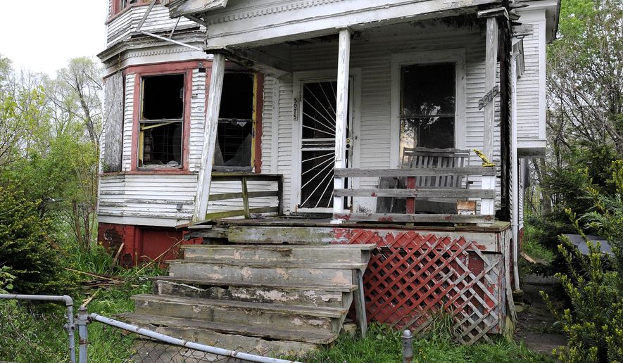 The house on the 5000 block of Parker, on Detroit’s east side, where fire fighters found the burned and stabbed body of Gracie Hughes, 56, after responding to a fire there early Thursday, May 12, 2016. Hughes grew up at the house, and was squatting in her childhood home, which was officially listed as abandoned. At a Mother's Day gathering last weekend, she told family members “I’m still on Parker Street.” (Todd McInturf/Detroit News via AP)