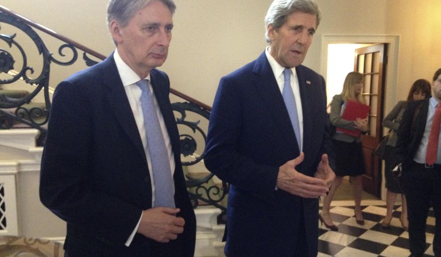U.S. Secretary of State John Kerry, right, and British Foreign Secretary Philip Hammond speak to reporters at Carlton Gardens in London Thursday, May 12, 2016, after meeting with key European bankers. Kerry is working to reassure European banks they won’t be penalized for conducting or facilitating legitimate business with Iran. (AP Photo/Josh Lederman)
