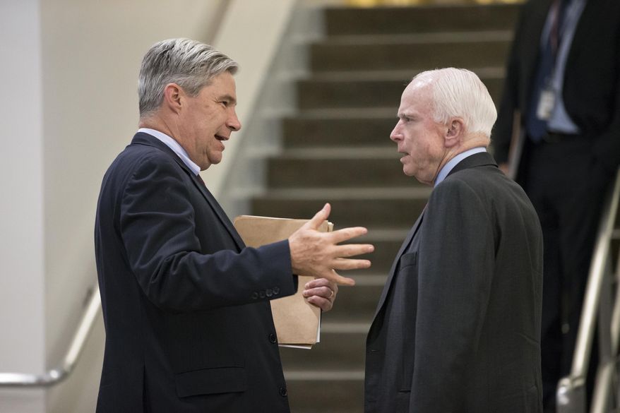 Sen. Sheldon Whitehouse, D-R.I., left, speaks with Senate Armed Services Committee Chairman Sen. John McCain, R-Ariz., on Capitol Hill in Washington, Thursday, May 12, 2016, as the Senate winds up its week . The Armed Services panel is moving to complete work on the military's budget, the National Defense Authorization Act. (AP Photo/J. Scott Applewhite)