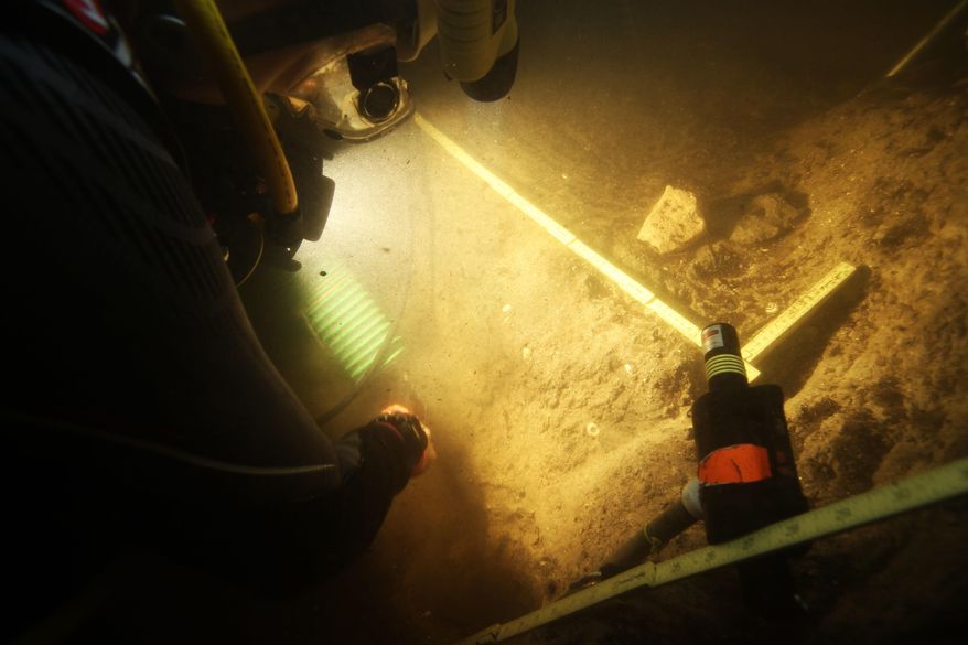 In this 2015 photo provided by Texas A&M's Center for the Study of the First Americans, divers investigate the Page-Ladson archaeological site in Florida. Scientists say artifacts found deep underwater in a Florida sinkhole show people lived in that area some 14,500 years ago. That makes it the earliest well-documented site for human presence in the southeastern U.S., and important for understanding the settling of the Americas, experts said. (S. Joy/CSFA via AP)