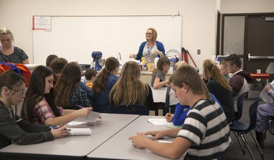 In this Wednesday, May 11, 2016 photo, Water Canyon High School students receive home economics instruction, in Hildale, Utah. The school in a polygamous community on the Utah-Arizona border that reopened two years ago unveiled a new building for high school students as the rebirth of the public education system in the town sets more roots. (Chris Caldwell /The Spectrum via AP) NO SALES; MANDATORY CREDIT
