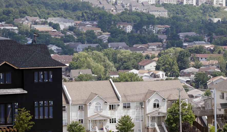 FILE - In this July 1, 2014, file photo, a new housing unit, left, is under construction in Kiryas Joel, N.Y. Agents with the FBI and other law enforcement agencies have seized documents from the Hasidic village on May 12, 2016, as part of an ongoing investigation. (AP Photo/Mike Groll, File)