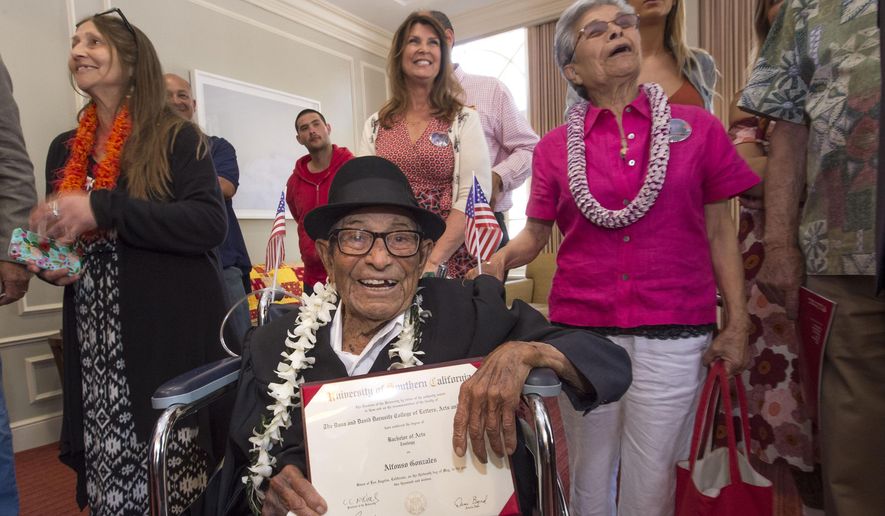 Alfonso Gonzales, 96, University of Southern California's oldest graduating Trojan receives his Bachelor of Science degree in zoology diploma from USC surrounded by family members, as part of the 2016 USC Commencement ceremony, on Friday, May 13, 2016 in Los Angeles. The World War II veteran thought he'd already graduated when he skipped commencement exercises in 1953 because of work obligations. He was founding a soil company that he ran for 55 years. But when relatives recently approached USC about getting a copy of his diploma, they learned he was one unit short. Although the school no longer offers a zoology major, it crafted an independent study course through the gerontology school that included reading, video assignments, visiting other classes, and writing a thesis about his life. (Gus Ruelas/USC via AP)