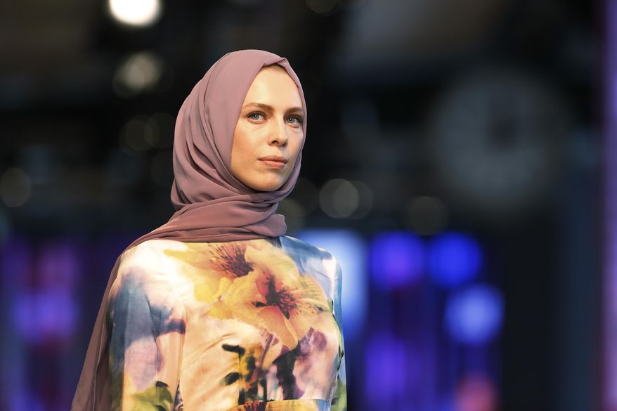 A model hits the catwalk of a fashion show during the International Modest Fashion Week, in Istanbul, Friday, May, 13, 2016. Turkey’s first International Modest Fashion Week has opened in Istanbul bringing designers and models of conservative wear from around the world. The two-day event kicked off Friday with models hitting the runway at a historic train station donning a bright palette of breezy garment and kaleidoscopic headscarves. (AP Photo/Lefteris Pitarakis)