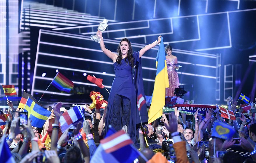 Ukraine's Jamala celebrates with the trophy after winning the Eurovision Song Contest final with the song '1944' in Stockholm, Sweden, Sunday, May 15, 2016. (AP Photo/Martin Meissner)