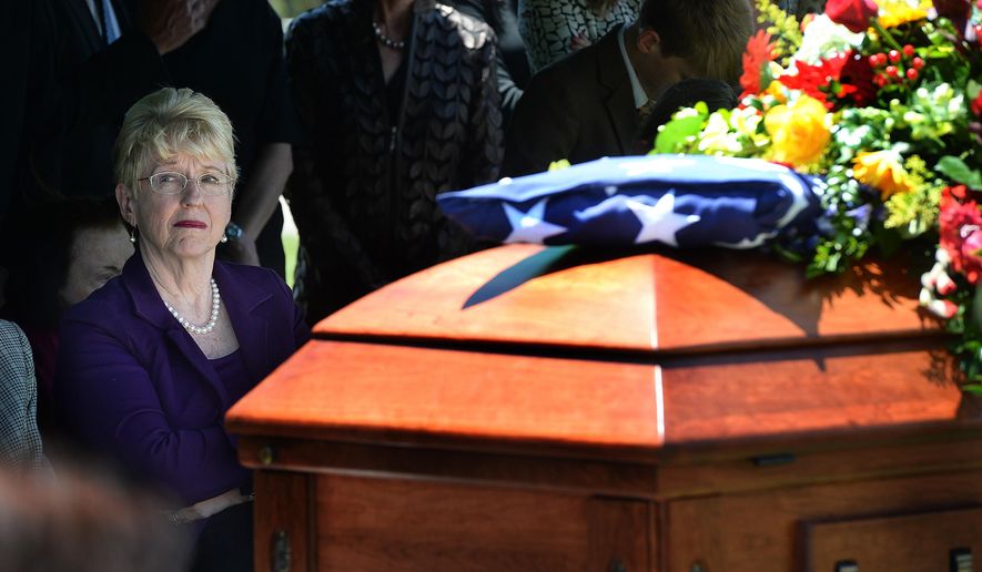 Joyce Bennett, the widow of former U.S. Sen. Bob Bennett, sits alongside his casket at the interment service at the Salt Lake City Cemetery, Saturday, May 14, 2016. (Scott Sommerdorf/The Salt Lake Tribune via AP)