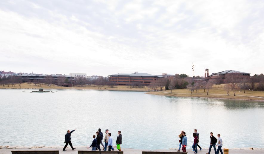 Architect Geoff DeOld, left, leads students through a tour of the ConAgra Campus Friday, March 4, 2016, in Omaha, Neb. Senior architecture students at the University of Nebraska-Lincoln were going to learn about urban planning by designing a mixed-use suburban development. Then ConAgra Foods announced it would move its headquarters to Chicago and reduce its Omaha workforce. The corporate campus, a riverfront landmark for decades, suddenly became a potential redevelopment site with serious implications for downtown Omaha's future. (Ryan Soderlin/The World-Herald via AP)