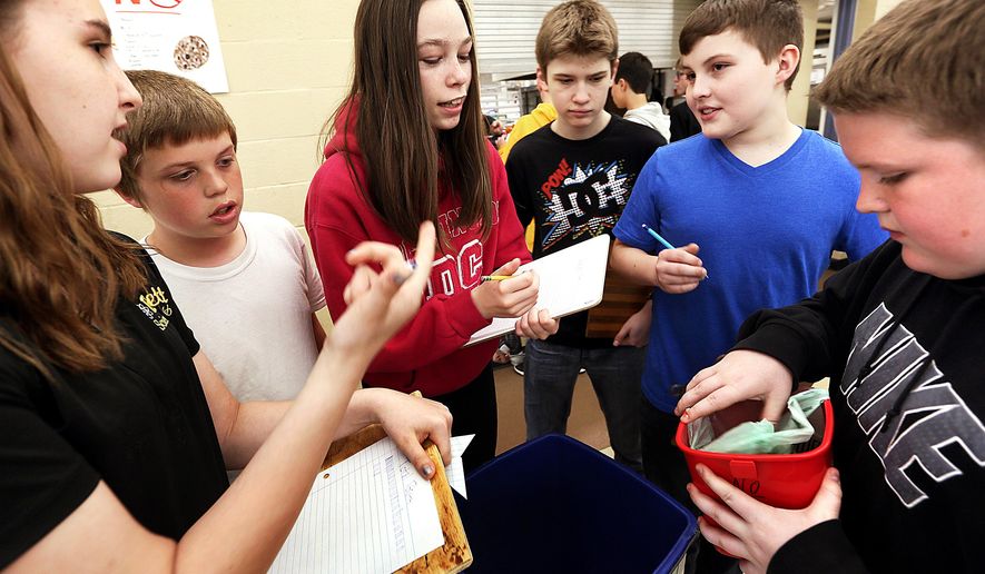 ADVANCE FOR USE SATURDAY, MAY 14 - In this photo taken April 29, 2016, students inspect buckets of food scraps from the cafeteria that will be used for composting at Bettendorf Middle School in Bettendorf, Iowa. Throughout the past six weeks, teach Nikki Armstrong has motivated her students to burst their Bettendorf bubbles and study water conservation, an issue several of them didn't know existed before this year. (Jeff Cook/Quad City Times via AP) MANDATORY CREDIT