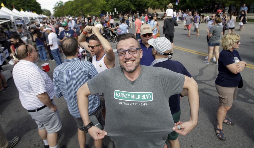 Daniel J. Bushman poses with his Harvey Milk t-shirt during a dedication event for a new Salt Lake City street named for pioneering gay leader Harvey Milk Saturday, May 14, 2016, in Salt Lake City. Signs bearing Milk's name have been added to parts of 900 South, near thoroughfares honoring civil rights icons like Martin Luther King Jr. and Cesar Chavez. (AP Photo/Rick Bowmer)
