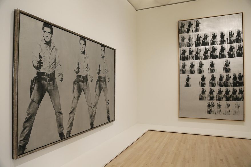 Silkscreen pieces by Andy Warhol showing Elvis Presley and Elizabeth Taylor are seen during a preview of the newly expanded San Francisco Museum of Modern Art Thursday, April 28, 2016, in San Francisco. The new museum opened to the public Saturday, May 14, 2016 with 19 inaugural exhibitions showcasing the work of artists like Diego Rivera, Henri Matisse, Andy Warhol and Mark Bradford. (AP Photo/Eric Risberg)