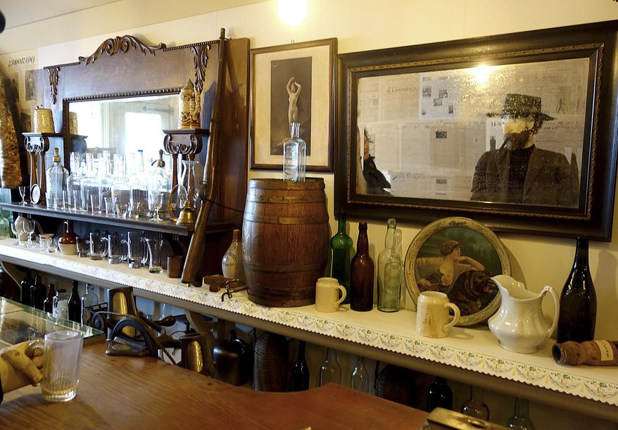 ADVANCE FOR WEEKEND MAY 14-15, 2016 AND THEREAFTER This April 30, 2016 photo shows a mannequin of Jefferson Randolph "Soapy" Smith, created by Martin Itjen, reflected in a mirror at the Jeff. Smith Parlor Museum during the museum's re-opening ceremony in Skagway, Alaska. The National Park Service, which was donated the museum and all its contents by the Rasmuson Foundation in 2008, recently completed an eight-year preservation and reconstruction effort. (Randi Spray/Capital City Weekly via AP) MANDATORY CREDIT