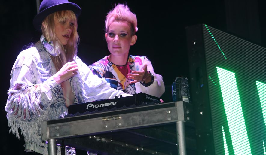 FILE - In this Dec. 16, 2013 file photo, Miriam Nervo, left, and Olivia Nervo of Nervo perform at the Gift at the Raymond James Stadium in Tampa, Fla. Electric Daisy Carnival in New York City - the annual ultra-popular electronic dance music extravaganza - features six women of the 80-plus performers on May 14-15, 2016. And lest you think that number seems low: “I think that sounds like a higher than normal number,” said Miriam Nervo, one-half of the Australian EDM duo NERVO, which includes her sister Olivia. (Photo by John Davisson/Invision/AP, File)