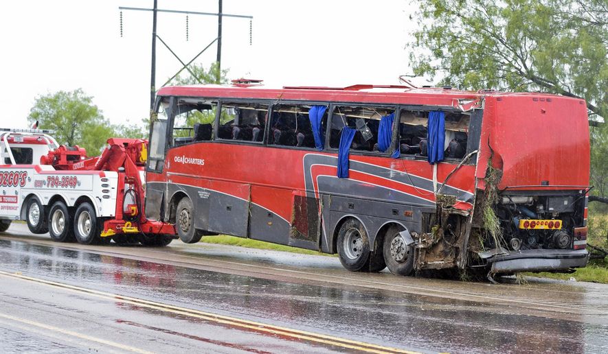A damaged OGA Charters bus is hauled away after a fatal rollover on Saturday, May 14, 2016, south of the Dimmit-Webb County line on U.S. 83 North in Texas. (Laredo Texas, Nuevo Laredo Mexico out, Mandatory credit Danny Zaragoza | Laredo Morning Times.)